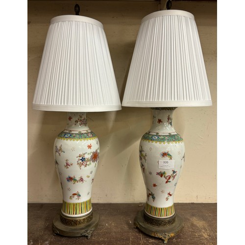 320 - A pair of oriental famille vert porcelain and gilt metal mounted table lamps