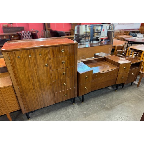 103 - An afromosia wood and black bedroom suite comprising, dressing table, tall boy and a bedside cabinet