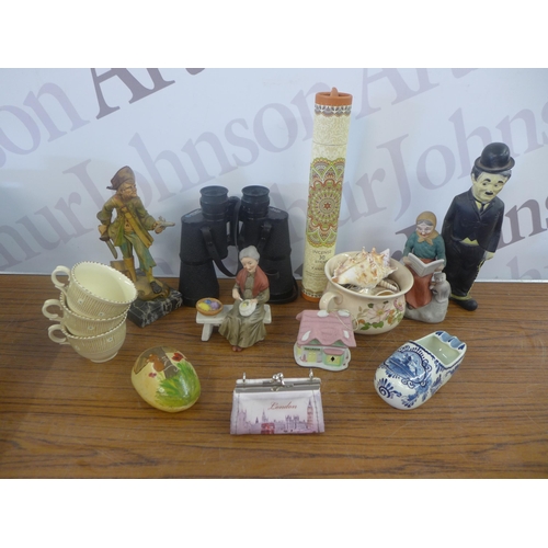 2344 - A crate of household ornaments including vases, cups, money boxes, binoculars, etc.