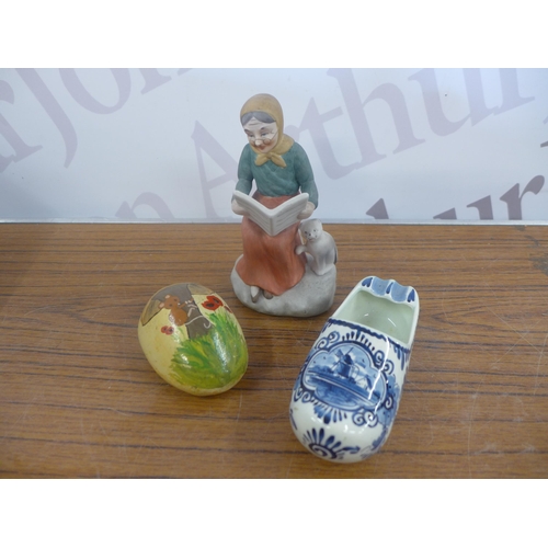 2344 - A crate of household ornaments including vases, cups, money boxes, binoculars, etc.