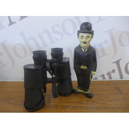 2344 - A crate of household ornaments including vases, cups, money boxes, binoculars, etc.