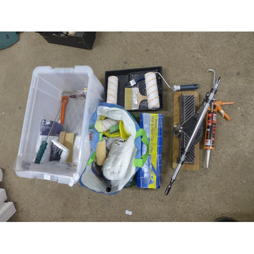 2391 - A large plastic box of decorating equipment, including rollers, paint brushes, tile cutter and mitre... 