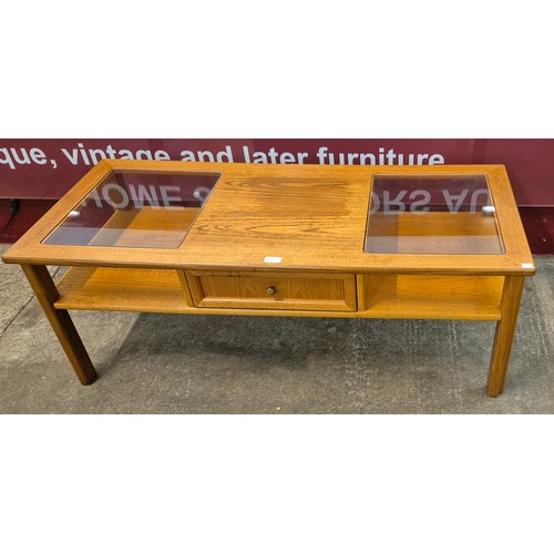 11 - A G-Plan teak and glass topped coffee table