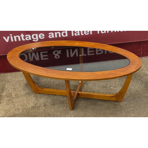 13 - A teak and glass topped oval coffee table