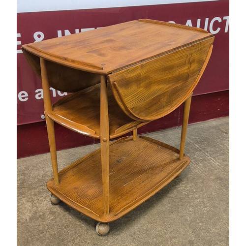 43 - An Ercol elm and beech Windsor drop leaf trolley