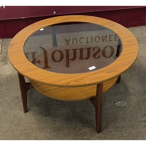 65 - A teak circular coffee table