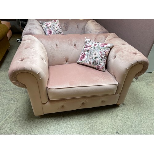 1455 - A pink velvet cuddle chair, brand new RRP £919