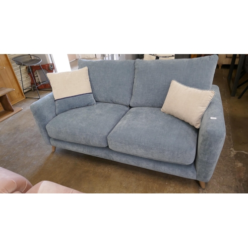 1472 - A blue velvet three seater sofa, brand new