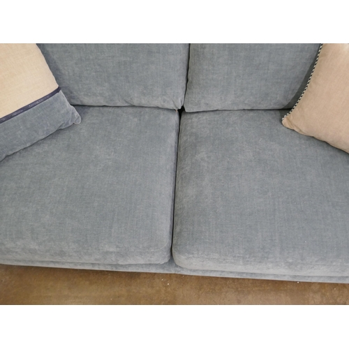 1472 - A blue velvet three seater sofa, brand new