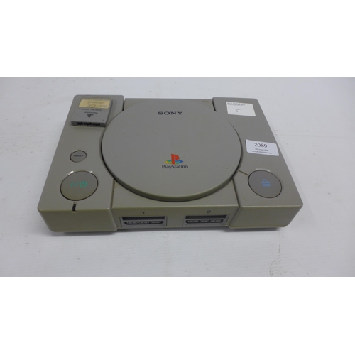 2089 - A Sony PlayStation One console with a PS2 eye toy, a dual shock 2 remote and vintage Bambino basketb... 