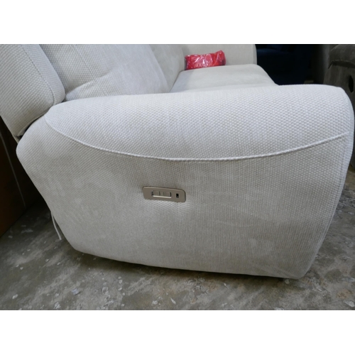 1423 - An ivory textured velvet electric reclining two seater sofa, brand new