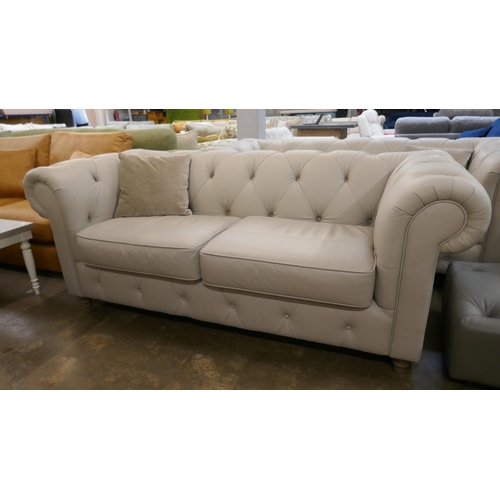 1429 - A stone leather Chesterfield three seater sofa, brand new RRP £1379