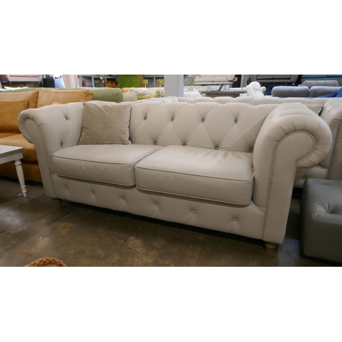 1430 - A stone leather Chesterfield three seater sofa, brand new RRP £1379