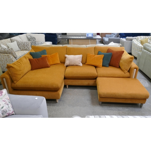 1301 - A burnt umber velvet large L shaped sofa and footstool with contrasting scatter cushions and semi ex... 