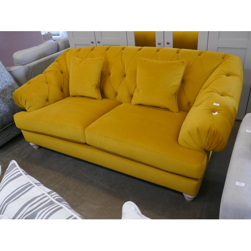 1488 - A gold velvet buttoned three seater sofa, brand new RRP £1399