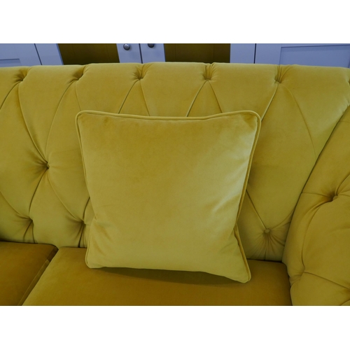 1488 - A gold velvet buttoned three seater sofa, brand new RRP £1399