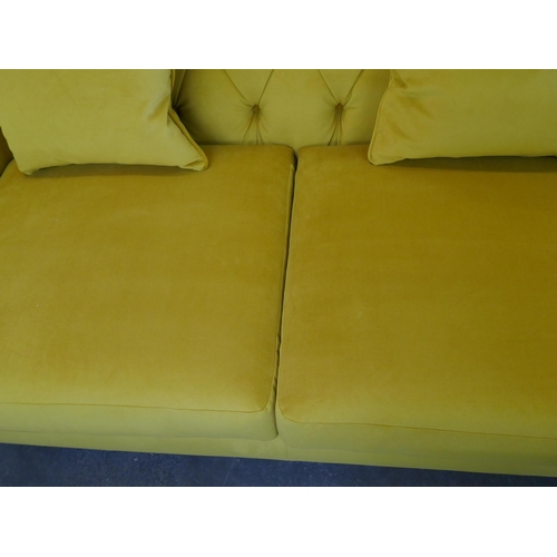 1488 - A gold velvet buttoned three seater sofa, brand new RRP £1399