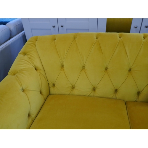 1488 - A gold velvet buttoned three seater sofa, brand new RRP £1399