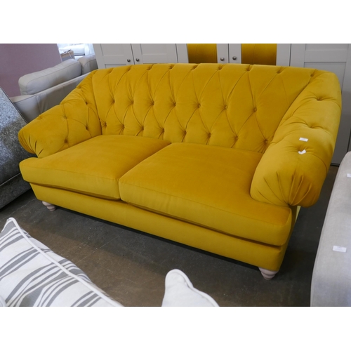 1488 - A gold velvet buttoned three seater sofa, brand new RRP £1399