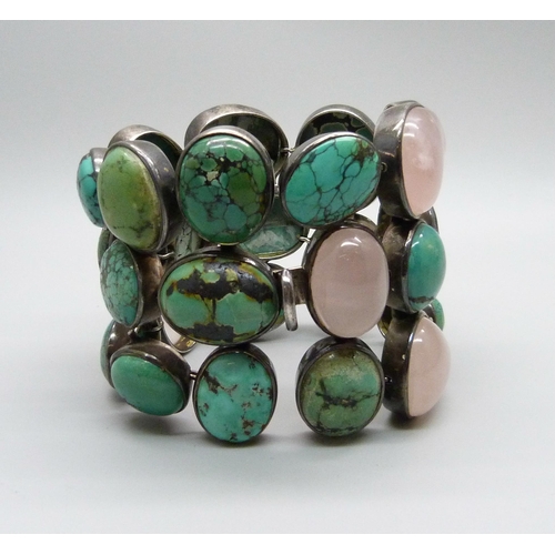 1009 - A large turquoise and stone set silver bracelet, 6.5cm wide, (three connections require weld repair)