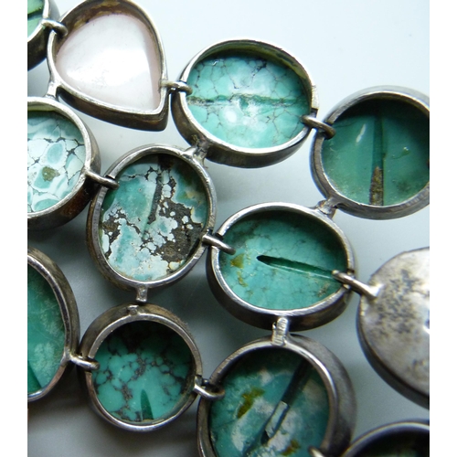 1009 - A large turquoise and stone set silver bracelet, 6.5cm wide, (three connections require weld repair)