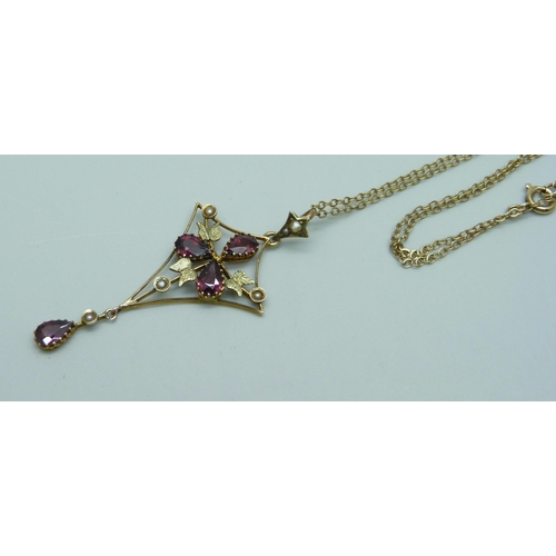 1043 - A almandine garnet and seed pearl pendant on a fine 9ct gold chain, total weight 3g, chain 44cm