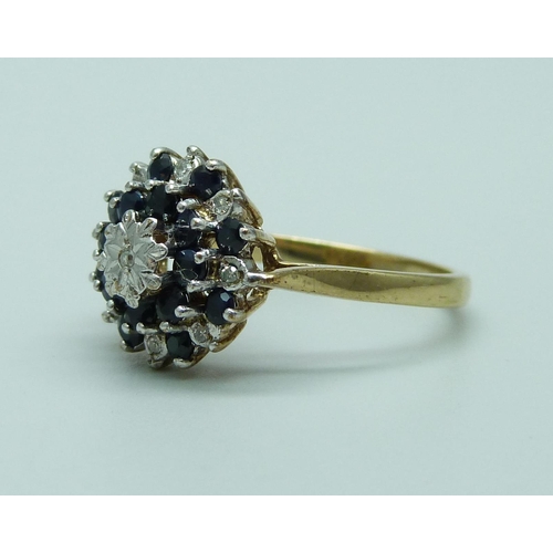 1051 - A 9ct gold, sapphire and diamond cluster ring (one diamond missing), 3.4g, R