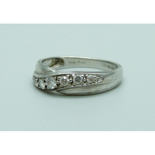 1054 - A 9ct white gold ring set with seven diamonds, 0.25ct weight, 2.5g, O