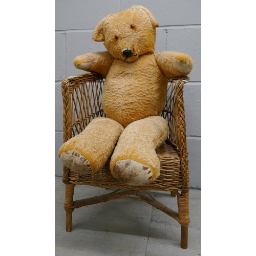 1093 - A large jointed Teddy on a wicker armchair (suitable for doll) **PLEASE NOTE THIS LOT IS NOT ELIGIBL... 