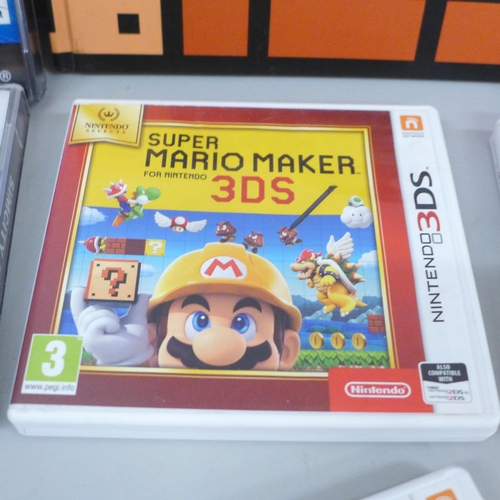 633 - Four Nintendo 3DS games including Mario Maker, with book, and two Playstation games, Sim City 2000 a... 