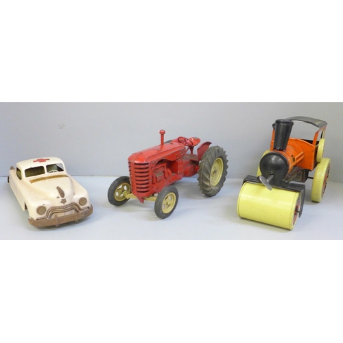 668 - A tin-plate model Ambulance by Arnold, made in Germany, U.S. Zone, a die-cast model tractor and a ti... 