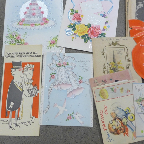 669 - A collection of mid-20th Century greetings cards and commemorative newspapers including Churchill