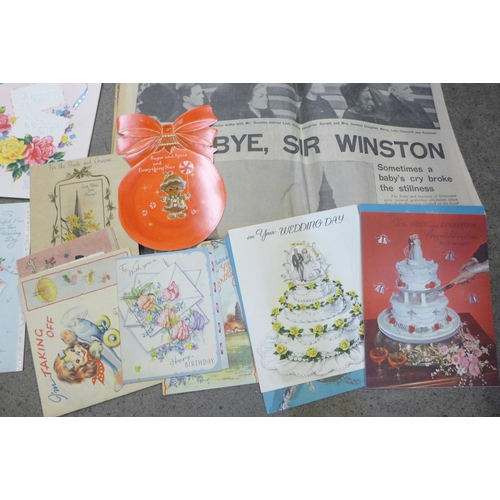 669 - A collection of mid-20th Century greetings cards and commemorative newspapers including Churchill