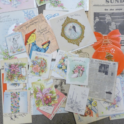 669 - A collection of mid-20th Century greetings cards and commemorative newspapers including Churchill