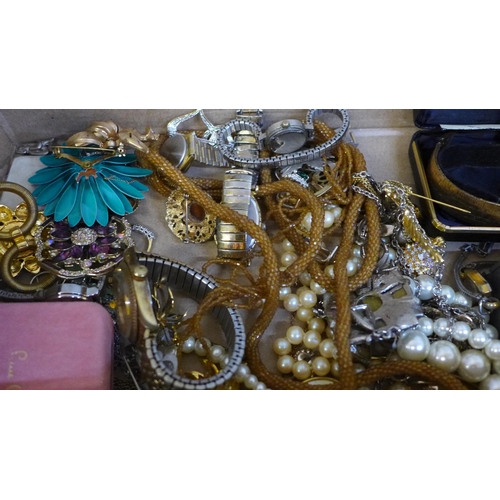 673 - A collection of costume jewellery, wristwatches, faux pearls, silver plated cruet set, etc.