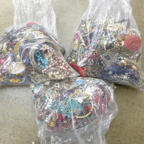 705 - Three bags of costume jewellery