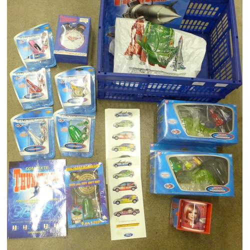 711 - A collection of Thunderbirds merchandise including an alarm clock, DVD and toy gift set, 2001 calend... 