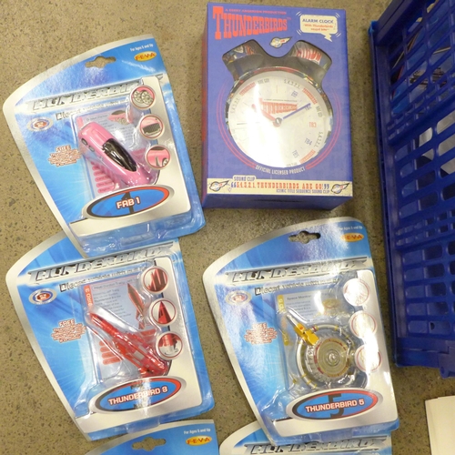 711 - A collection of Thunderbirds merchandise including an alarm clock, DVD and toy gift set, 2001 calend... 