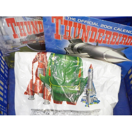 711 - A collection of Thunderbirds merchandise including an alarm clock, DVD and toy gift set, 2001 calend... 