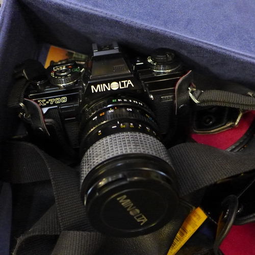 719 - A Minolta X-700 camera and an X-500 camera, three spare lenses, etc.