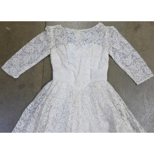 765 - A lace wedding dress, with photograph of it worn at a Wedding ceremony in 1961 by the vendors mother... 