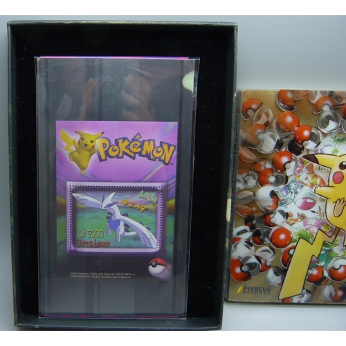 823 - A 1998 Pokemon Japanese Pikachu promo CD set, lacking cards, together with a 2000 Topps Pokemon TV o... 