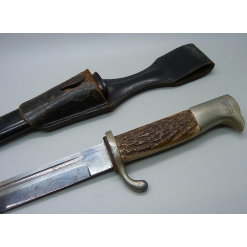 837 - A German bayonet with scabbard, horn handle, the blade marked Horster, Solingen **PLEASE NOTE THIS L... 