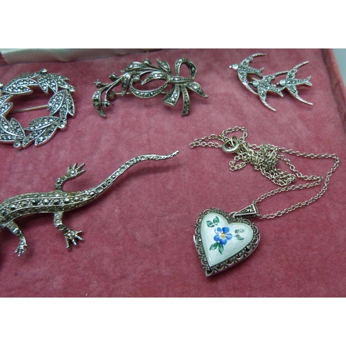 860 - A silver and enamelled locket and chain and four marcasite set brooches, (two marked 925, not lizard... 