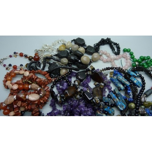 890 - A collection of gemstone jewellery including amethyst, goldstone, tigers eye, etc.