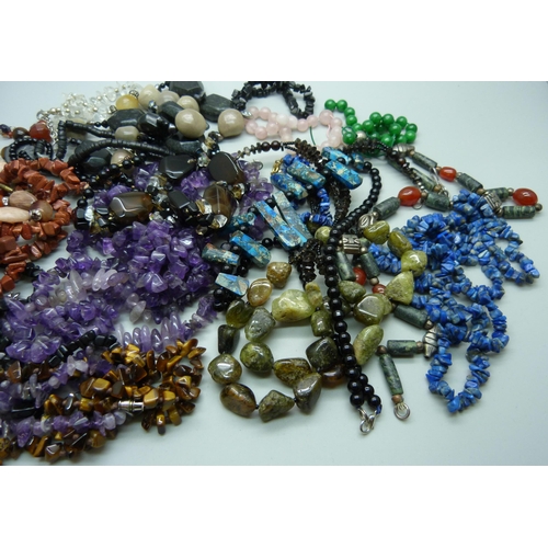 890 - A collection of gemstone jewellery including amethyst, goldstone, tigers eye, etc.