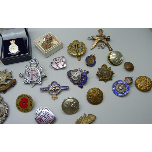 900 - A collection of military cap badges, buttons, other badges, etc.