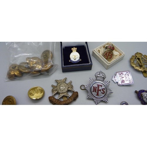 900 - A collection of military cap badges, buttons, other badges, etc.