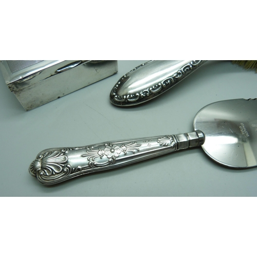 904 - A silver backed hair brush, a silver box and a silver handled cake knife