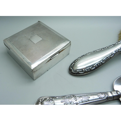 904 - A silver backed hair brush, a silver box and a silver handled cake knife